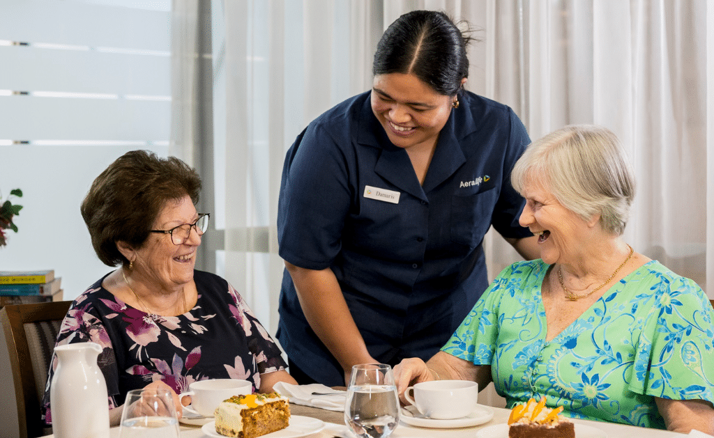 Aeralife carer and two aged care residents enjoying tea and company.